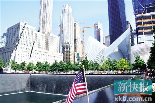 “9・11”遗址,水池边上多了一面美国国旗,一名男子指着水池边上的名字对身旁的孩子说,“这些人都是英雄。”