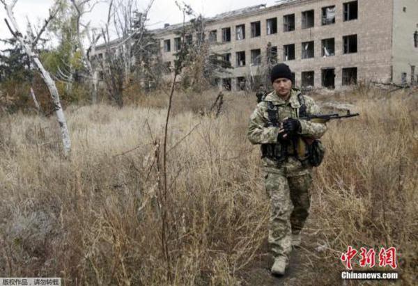 当地时间2015年10月27日，乌克兰军方与民间武装在顿涅茨克机场附近爆发冲突，乌克兰军人出现伤亡。图为乌克兰军人正在调查Pisky村附近的一座被摧毁的建筑物。 