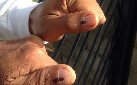 Voters show off their thumbs after placing their votes. Picture: Shamiela Fisher/EWN.