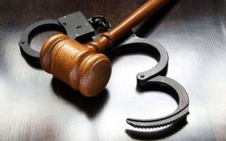 Gavel on cuffs. Picture: SAPS