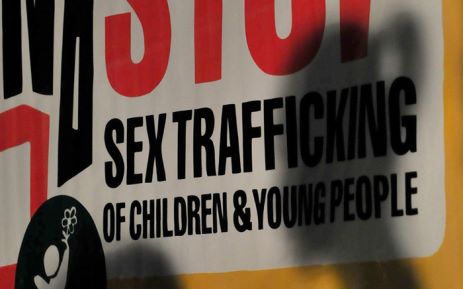 Children are silhouetted in front of posters displayed during a prayer for Justice and Protection against Sex Trafficking of Children and Young People in Quezon City suburban Manila on 12 December, 2010, as part of the annual observance of International Day against Human Trafficking. Picture: AFP.