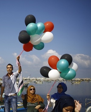 Palestinians show their solidarity with a Gaza-bound flotilla of international activists attempting to break the Israeli blockade on the Hamas-run Gaza Strip. (Mohammed Abed, AFP)