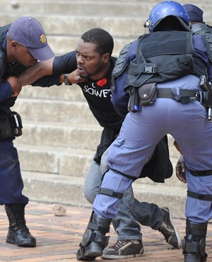 Police attempt to arrest activist Mcebo Dlamini on the Wits campus during this week’s protests. (Felix Dlangamandla, Netwerk24)