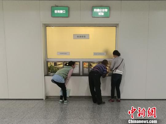 图为医院体液检验窗口，患者需要蹲着与医生沟通。　张枭　摄