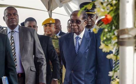 FILE: Former Zimbabwean President Robert Mugabe (right) arrives for a graduation ceremony at the Zimbabwe Open University in Harare on 17 November 2017. This is his first public appearance since a military takeover on 14 November 2017. Picture: AFP