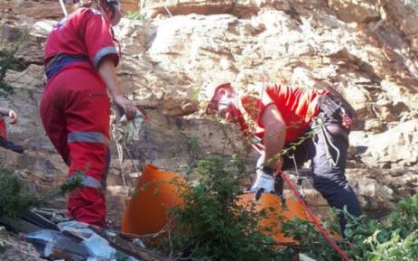 ER24 paramedics recovering the body of a woman who had fallen several metres off a mountain in Rustenburg. Picture: ER24. 
