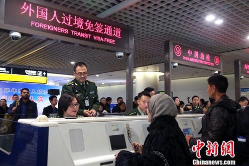资料图：边检民警为入境旅客办理通关手续。中新社记者 王磊 摄