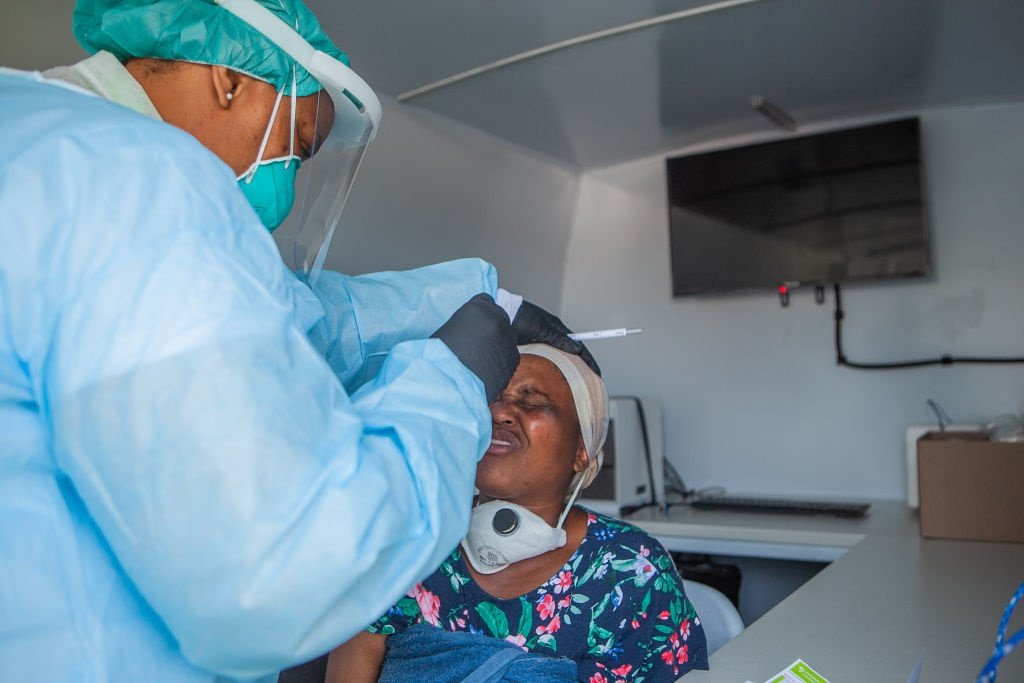 A health worker screens  a resident at Diepsloot for Covid-19.