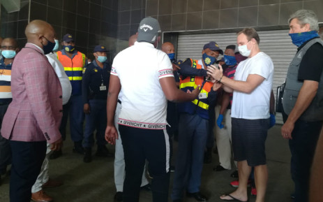 Gerard Jansen Van Vuuren is handcuffed by police at Johannesburg International Airport after being extradited from Brazil to stand trial for allegedly stabbing his ex-girlfriend to death in Johannesburg in 2011. Picture: SAPS.